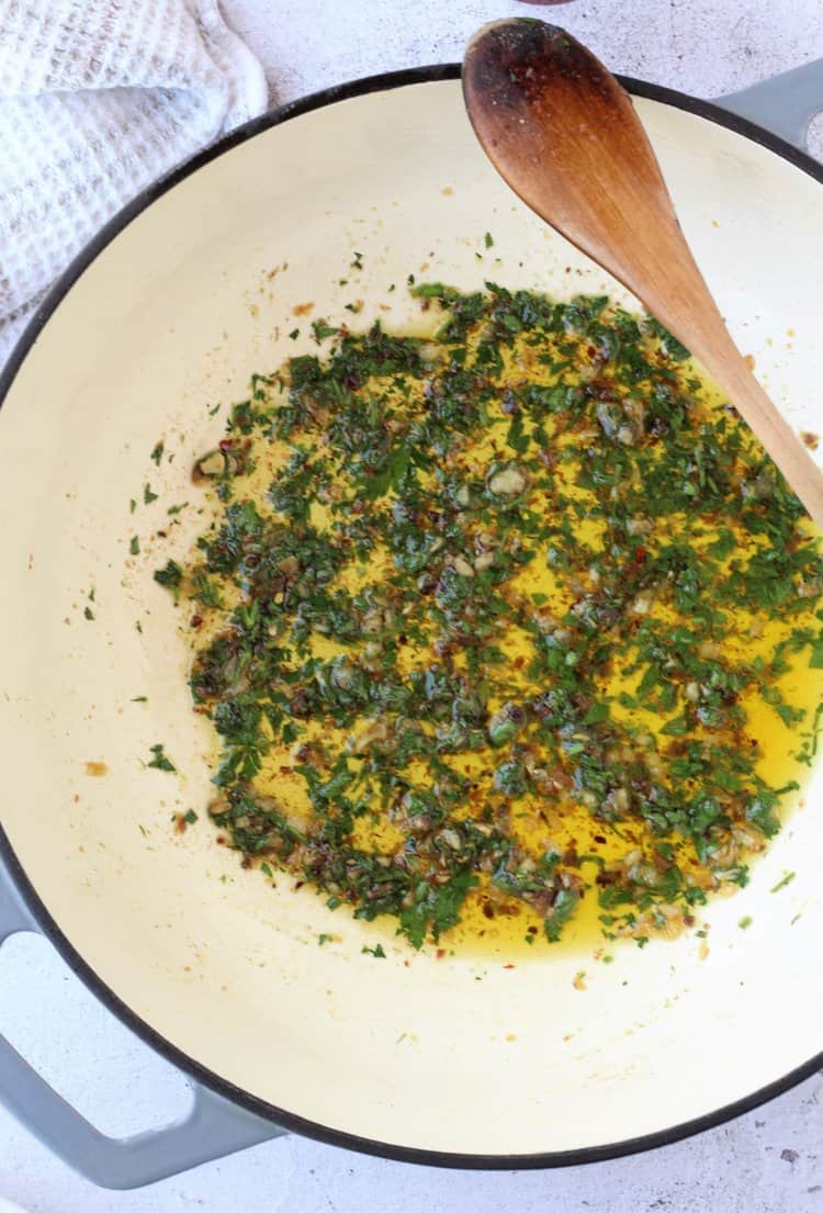 Parsley, garlic and anchovy sauce in pan.