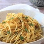 Spaghetti with breadcrumbs and anchovy in bowl.