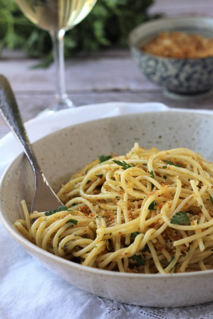 Bowl with spaghetti and breadcrumbs.