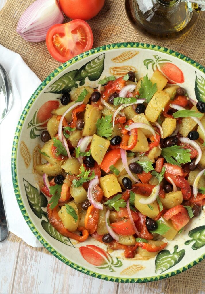 Large salad bowl with potato, roasted pepepr and tomato salad.