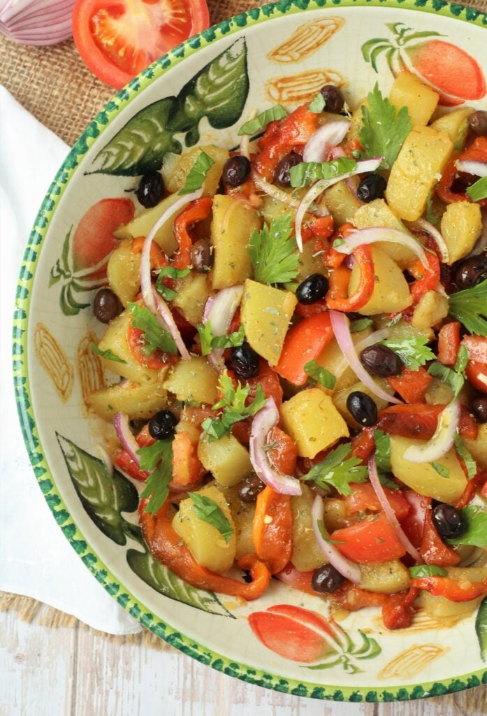 Tossed Italian potato salad with roasted red peppers and tomatoes.