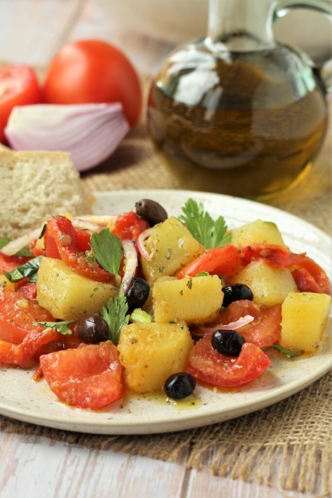 Plated potato, roasted red pepper and tomato salad.