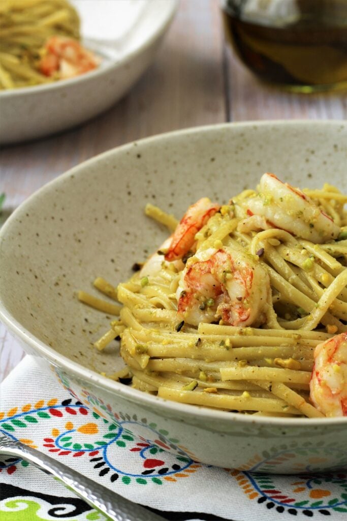 Plated pistachio pesto and shrimp pasta.