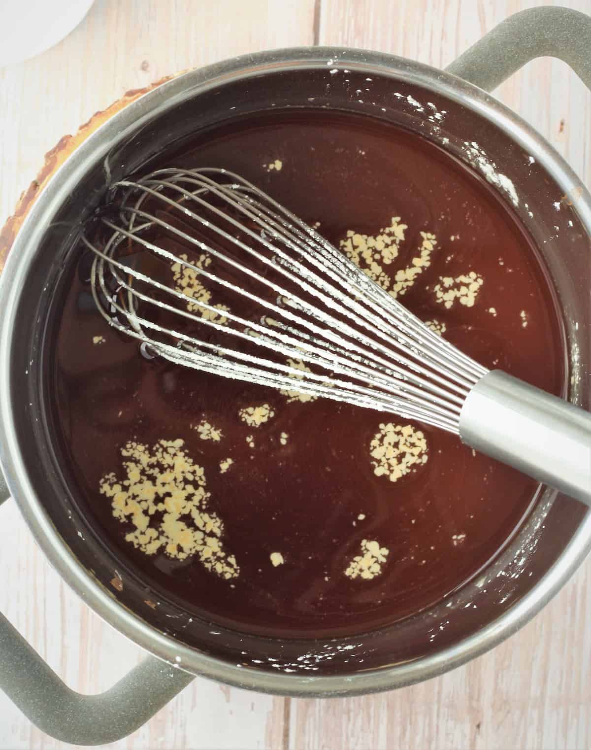 Coffee mixture with cornstarch whisked into it in sauce pan.
