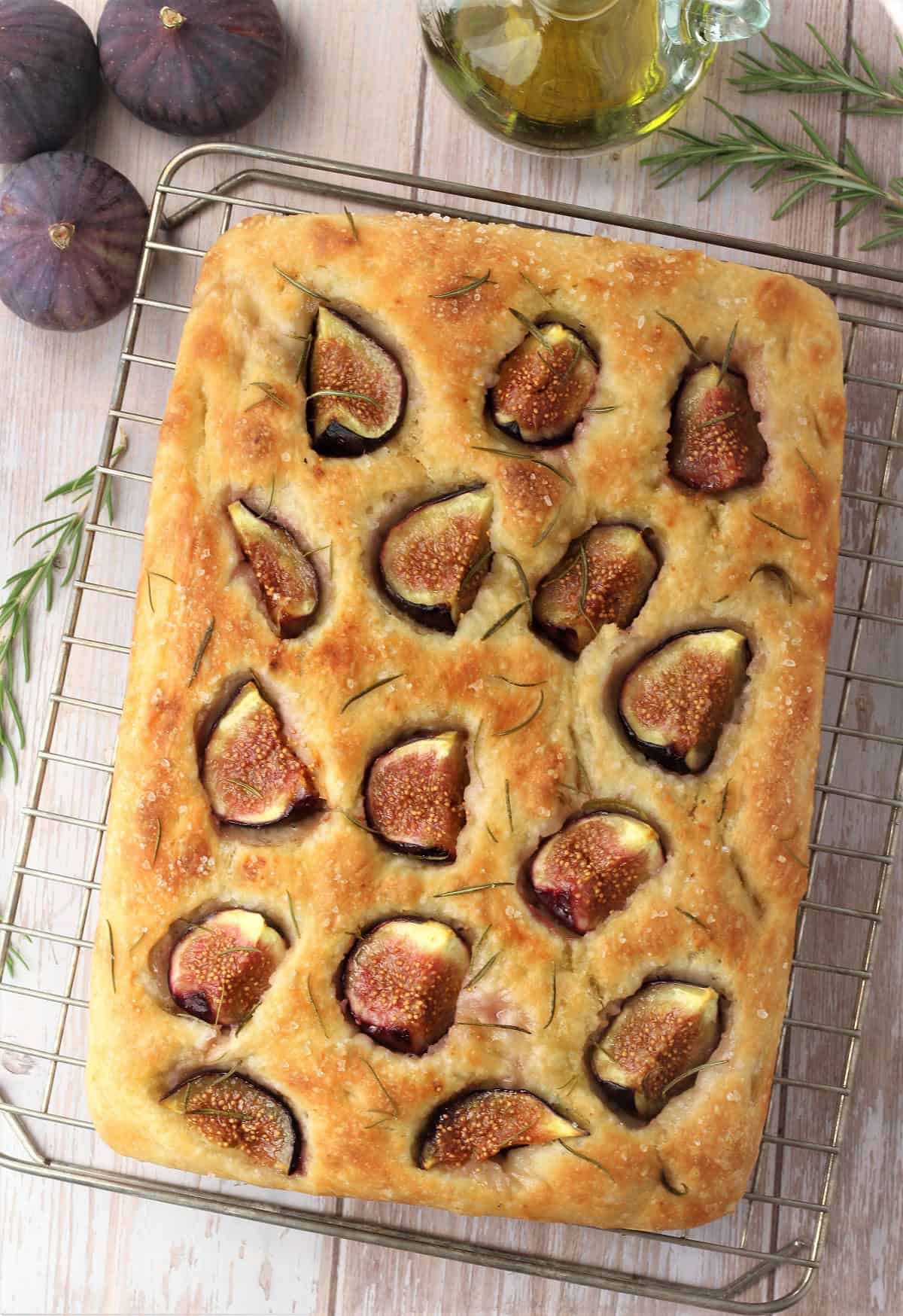 No knead fig and rosemary focaccia on wire rack.