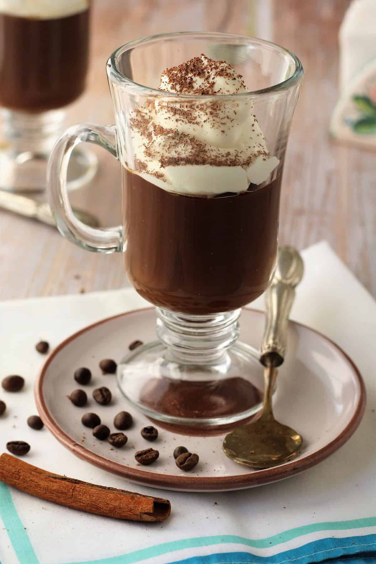 Sicilian coffee pudding (gelo di caffè) in glass topped with whipped cream.