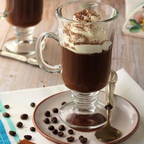 Sicilian coffee pudding (gelo di caffè) served in glasses topped with whipped cream.