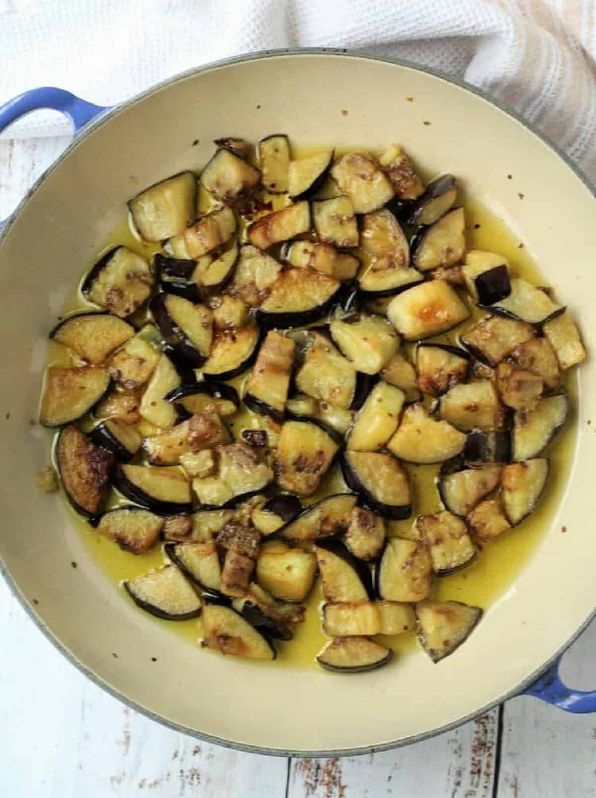 Eggplant cubes fried in olive oil in large skillet.