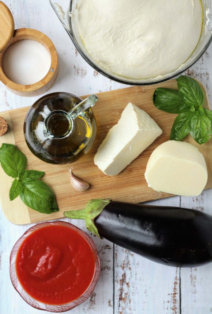 Pizza dough, tomato sauce, eggplant, cheese, basil and olive oil.