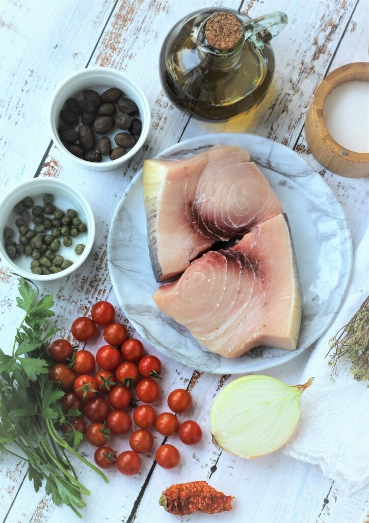 Swordfish steaks, cherry tomatoes, onion, capers, olives and oil.