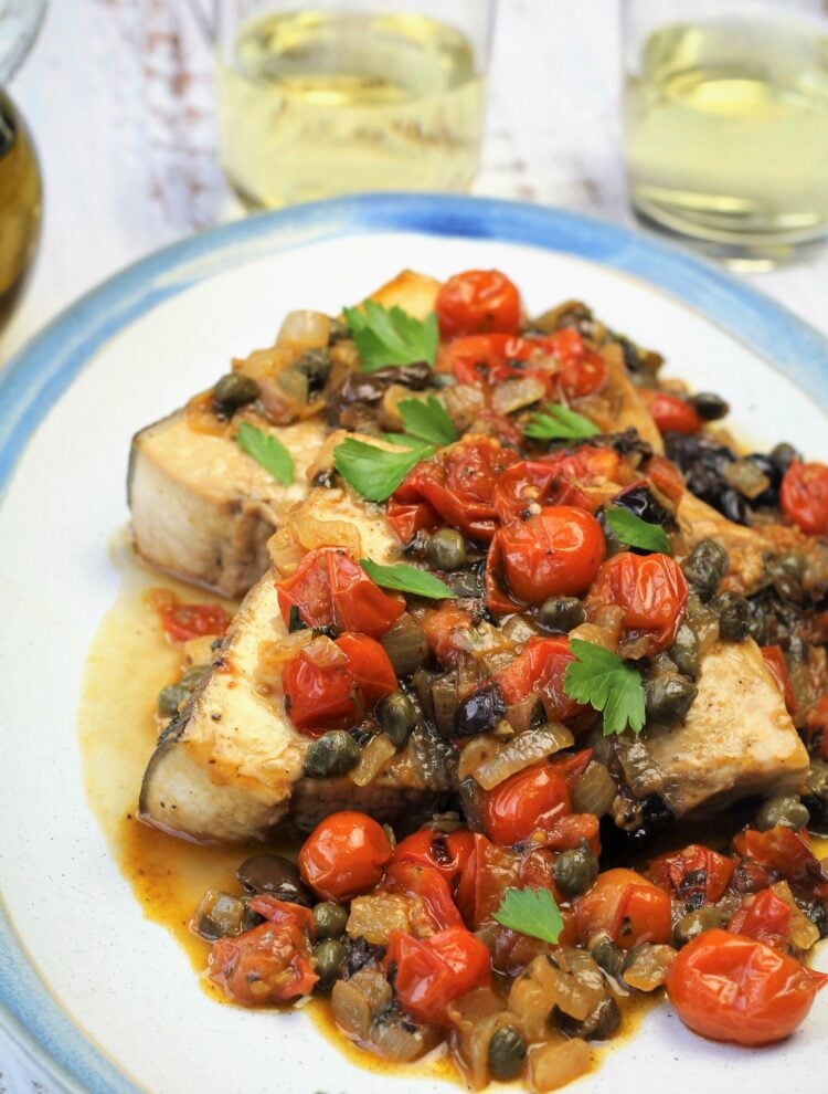 Plated Sicilian swordfish with cherry tomato sauce.