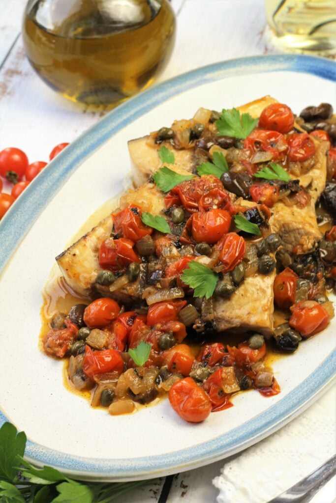 Sicilian swordfish with tomatoes, capers and olives.