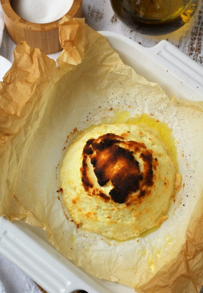 Golden crusted baked ricotta in baking dish.
