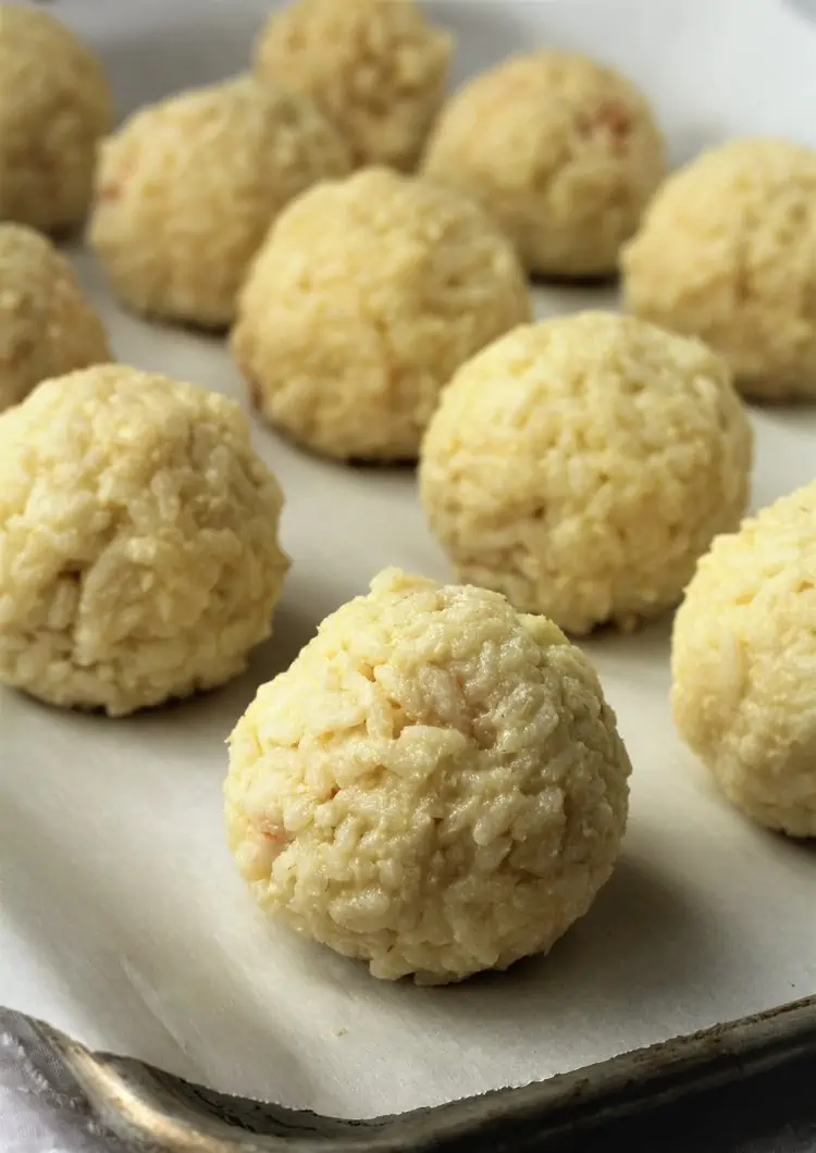 Assembled rice balls on baking sheet.