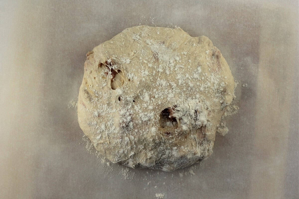No knead fig and walnut bread dough on parchment paper.
