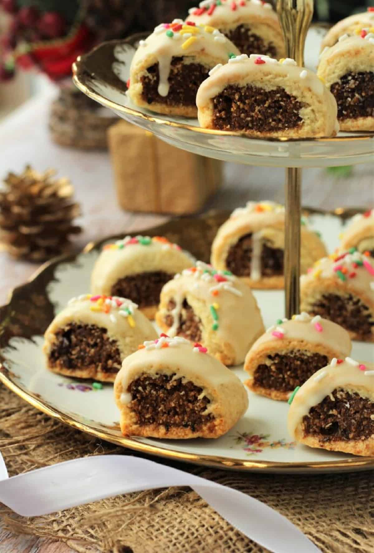 Cuccidati cookies with figs on tiered cookie plate.