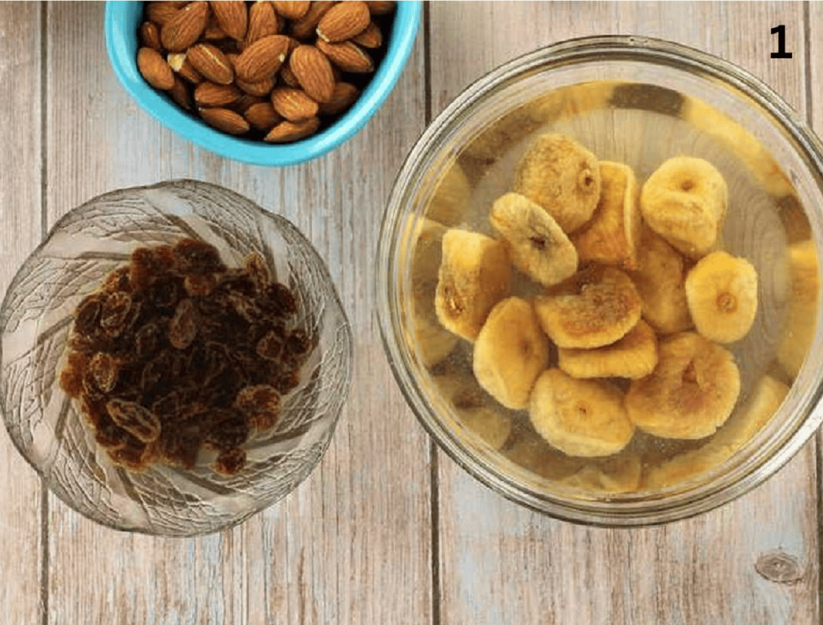Dry figs and raisins in bowls covered in water and bowl of almonds.
