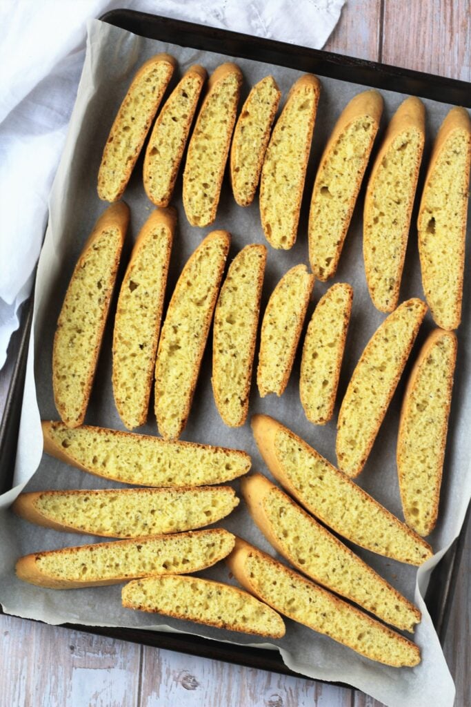 Biscotti with anise seed on baking sheet.
