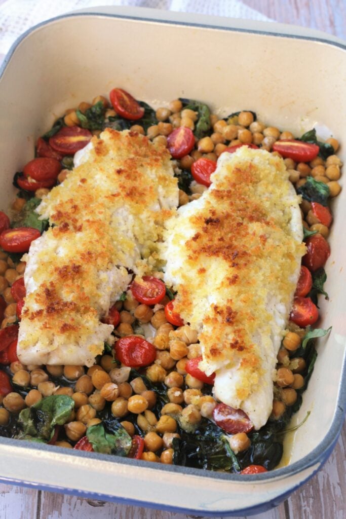 Crispy oven baked fish over chickpeas, spinach and tomatoes.