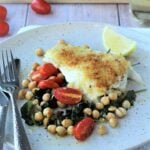 Crispy oven baked fish with chickpeas, spinach and tomatoes.