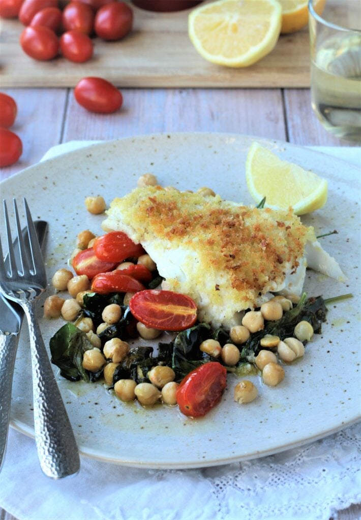Crispy oven baked fish with chickpeas, spinach and tomatoes.
