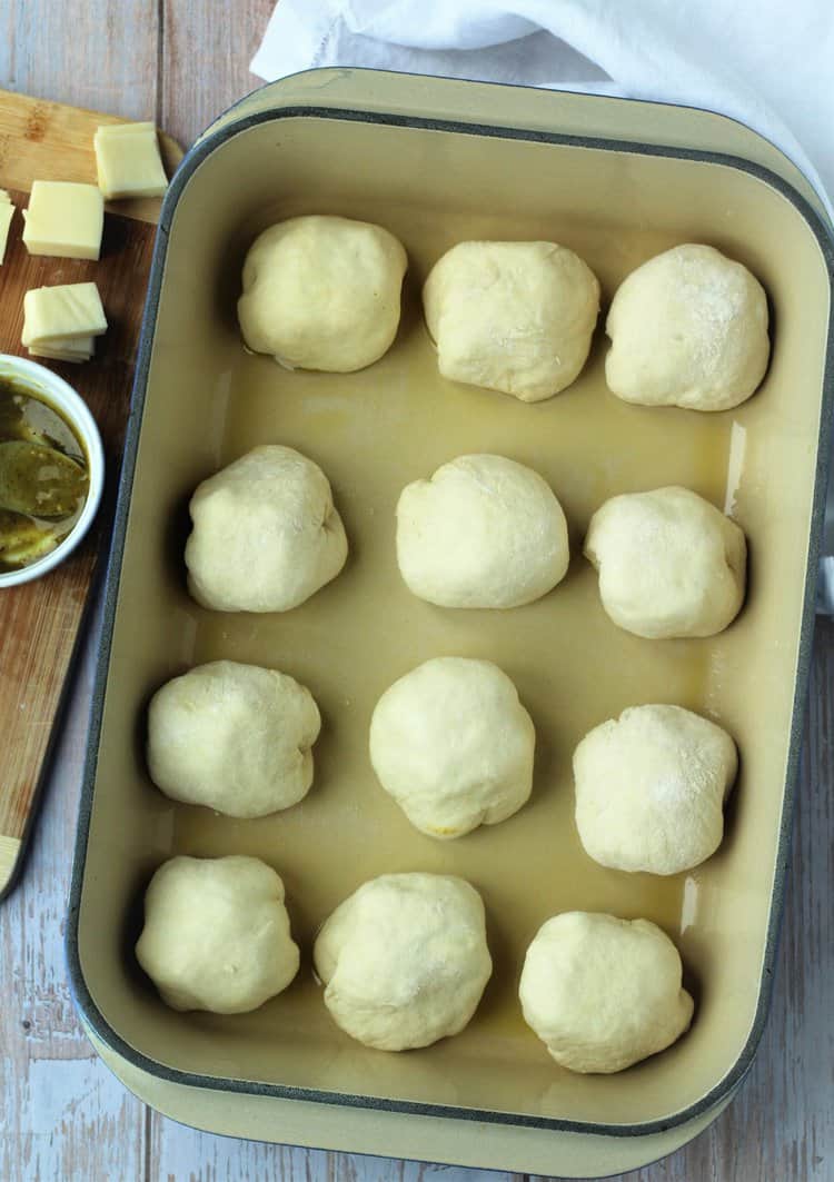 Stuffed bread rolls on baking pan.