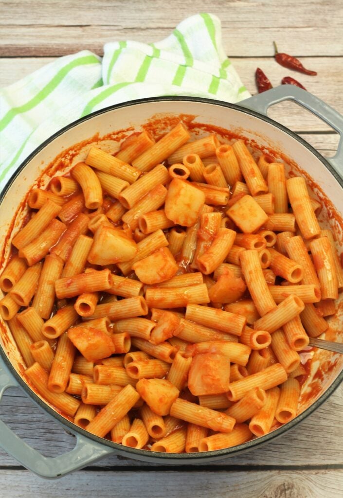 Large skillet filled with pasta and potato tomato sauce.