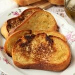 Italian fried bread slices on white plate.