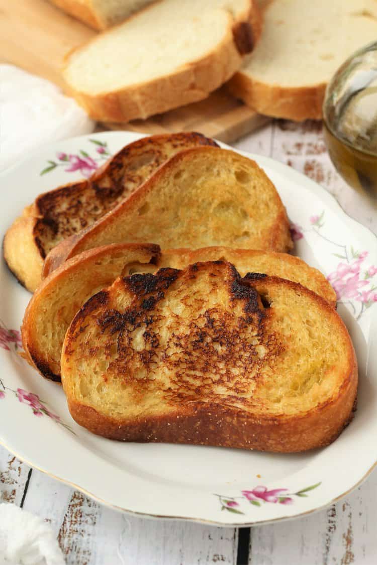 Italian fried bread slices on white plate.