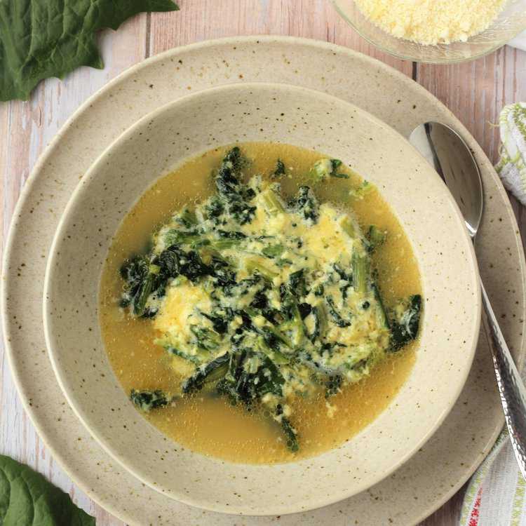 Italian chicory, eggg and cheese soup in a bowl.