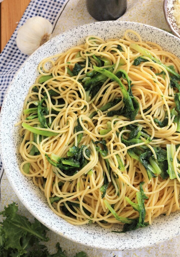 Large bowl filled with garlicky sautéed escarole spaghetti.