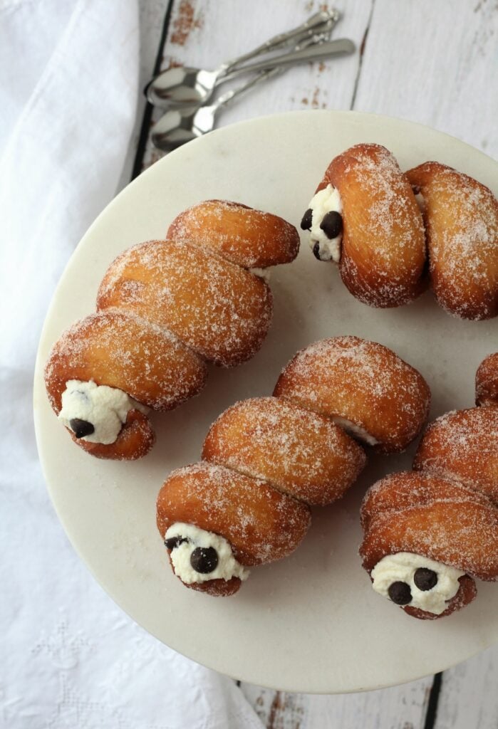 Cartocci siciliani with ricotta filling on plate.