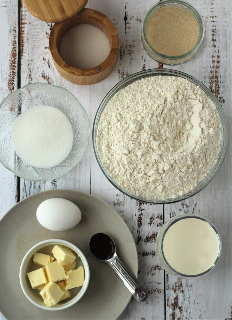 Bowl of flour, sugar, yeast, salt, butter, vanilla and an egg.