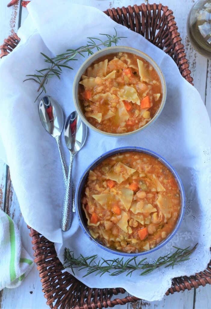 Bowls of chickpea pasta with spoons. 