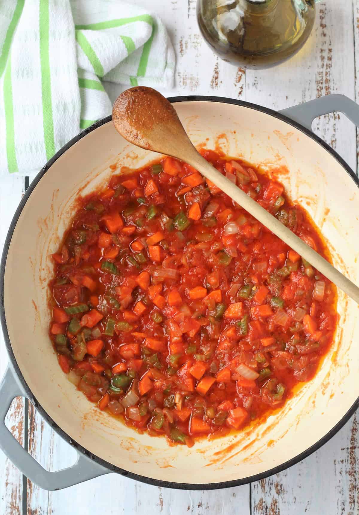 Tomato sauce added to skillet with soffrito for chickpea pasta.
