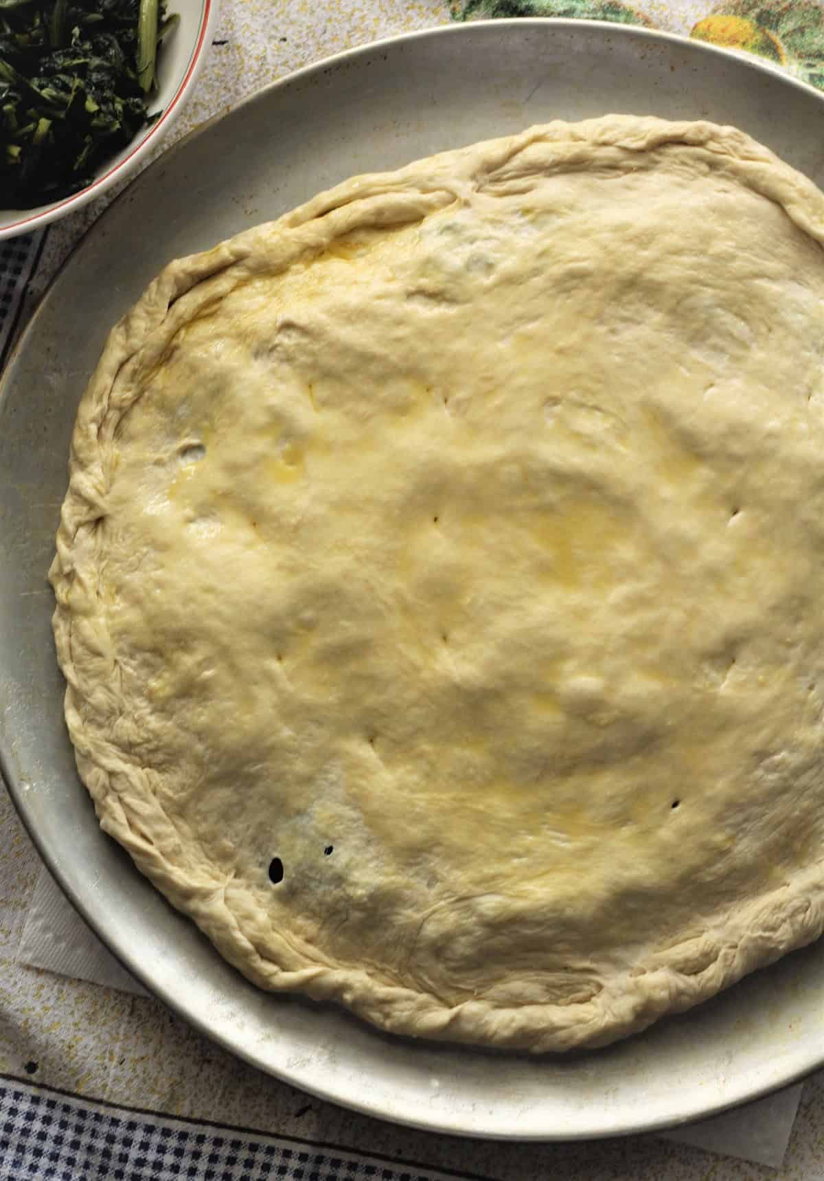 Double crust pizza dough stuffed with chicory, egg and cheese. 