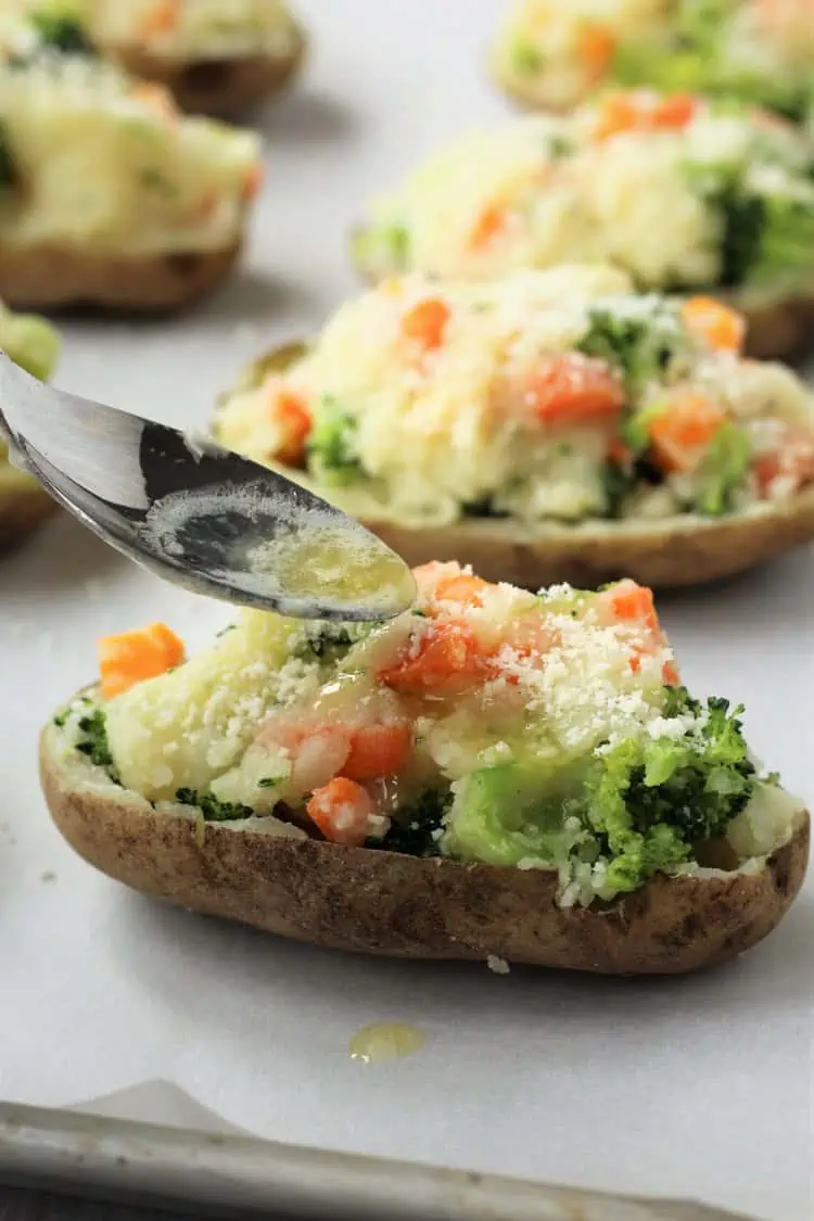 Melted butter spooned  on stuffed potato halves.