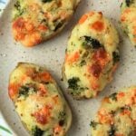 Stuffed broccoli and cheese baked potatoes on plate.