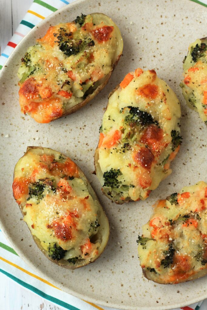 Stuffed broccoli and cheese baked potatoes on plate.