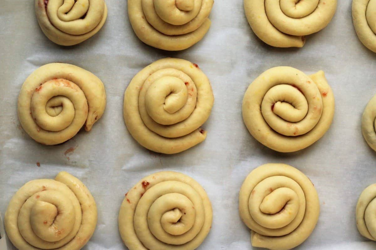 Brioche swirls on baking sheet.