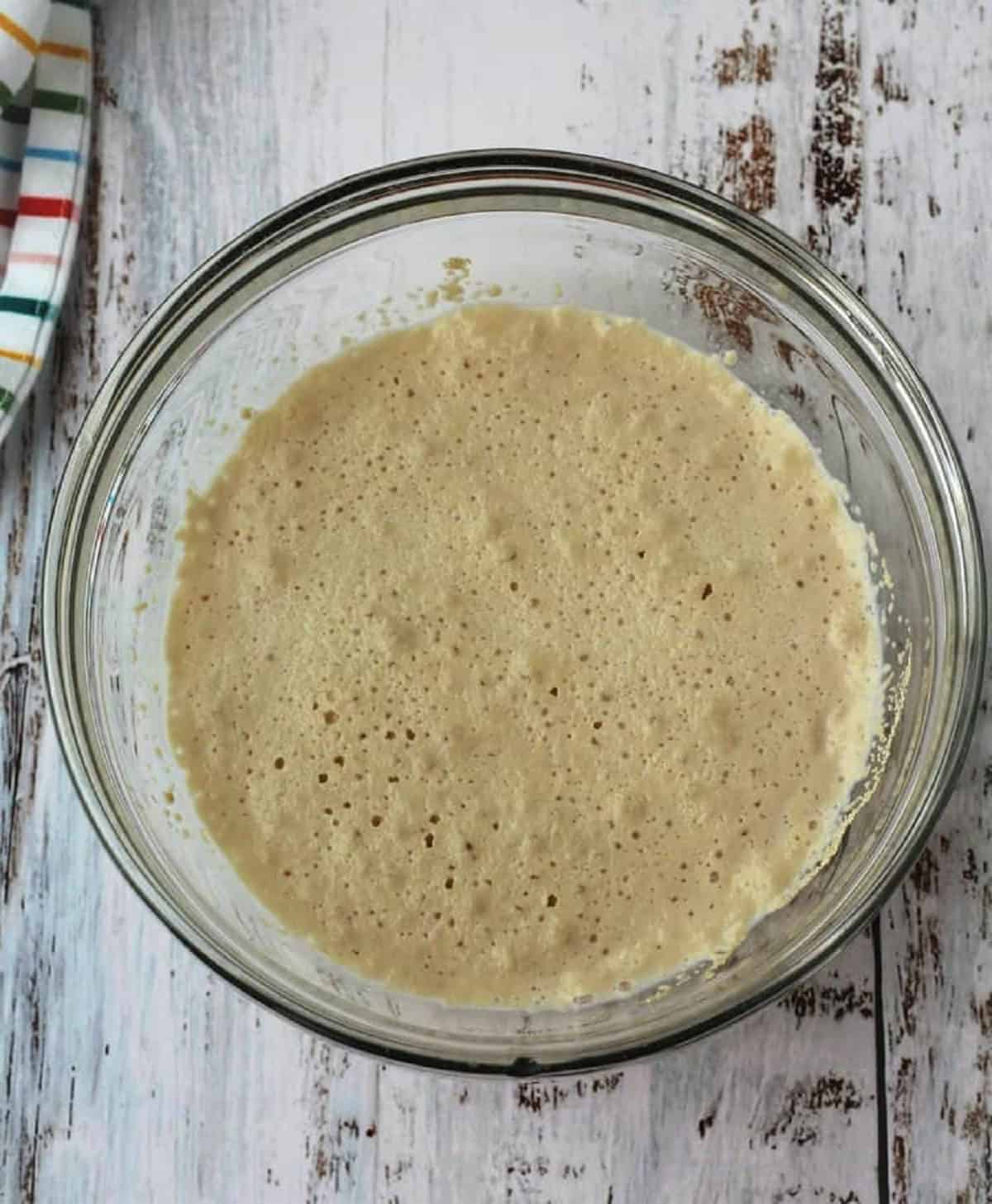Proofed yeast in glass bowl for brioche swirls.
