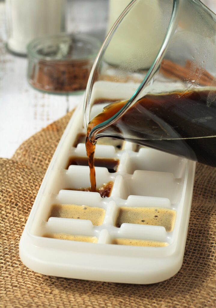 Pouring coffee in ice cube tray.
