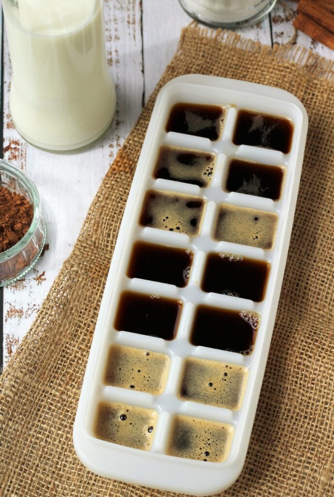Ice cube tray filled with espresso coffee for iced cappuccino.
