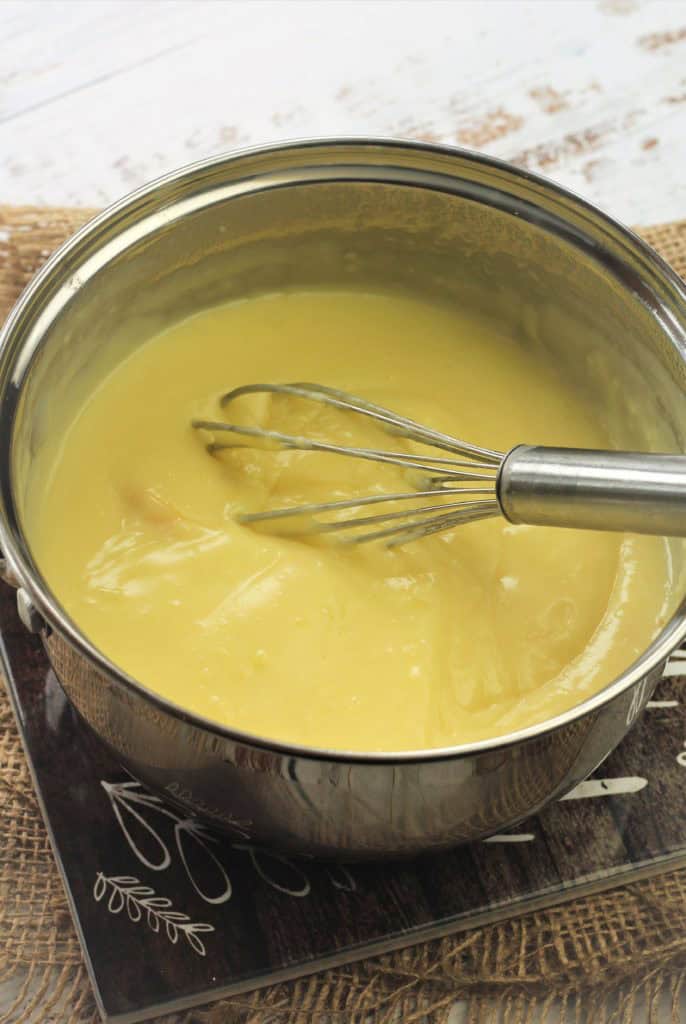 Whisking pastry cream in sauce pan.