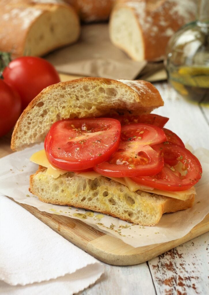 Thinly sliced tomatoes on Sicilian sandwich with cheese, olive oil and oregano.