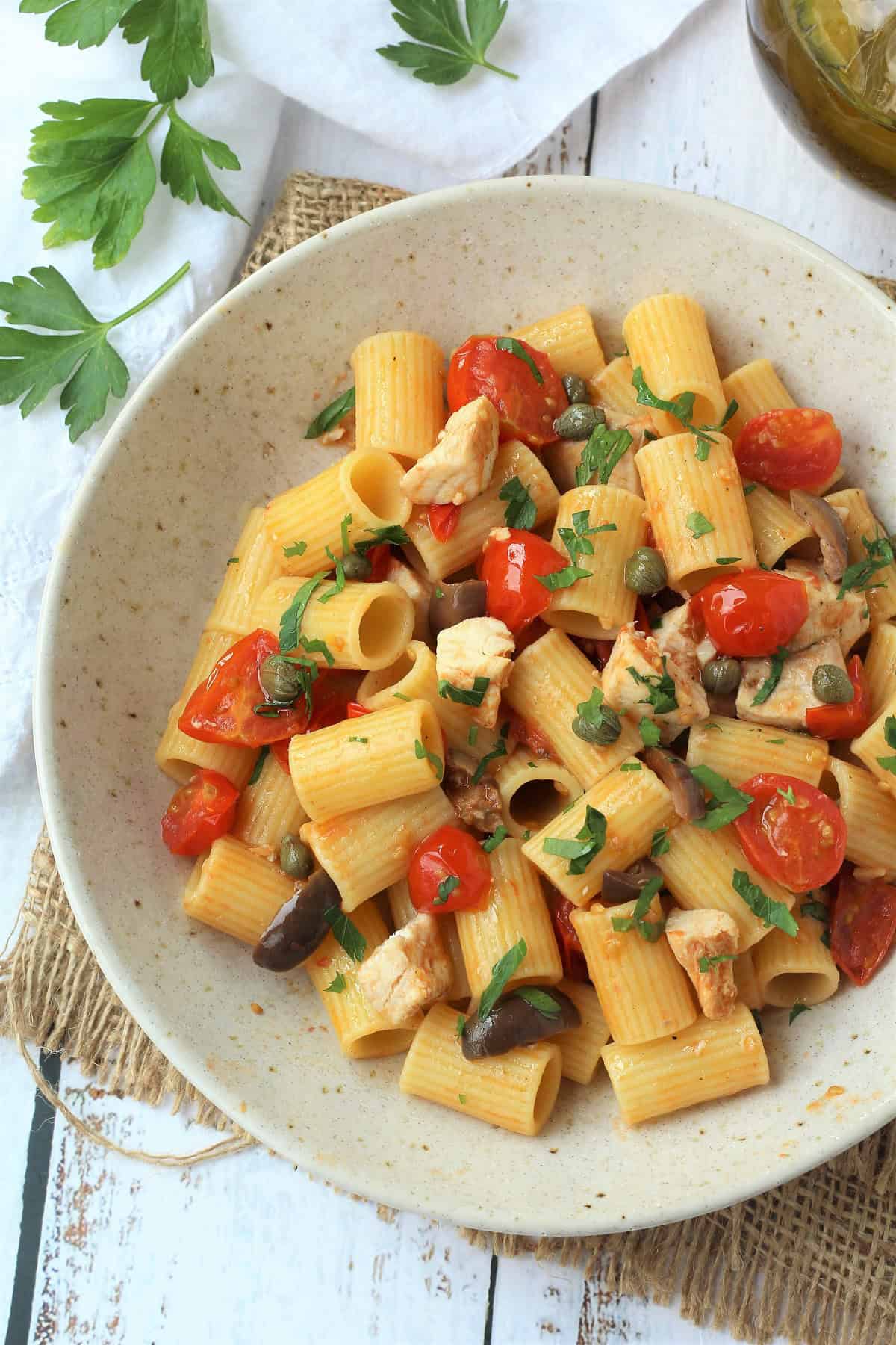 Sicilian pasta with swordfish in tomato sauce in bowl. 