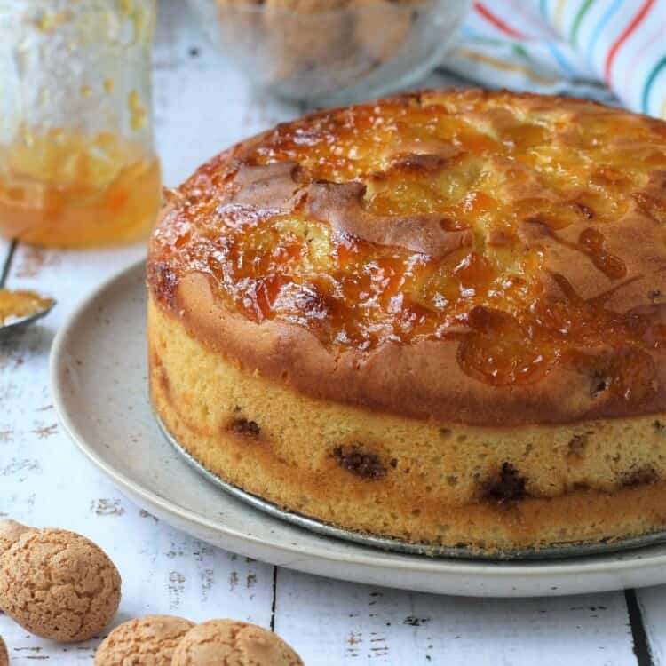 Apricot glazed Italian amaretti cake on plate.