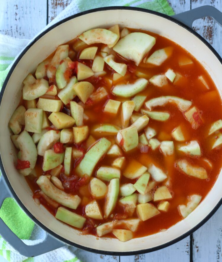 Stewed cucuzza with potatoes and tomatoes in skillet.