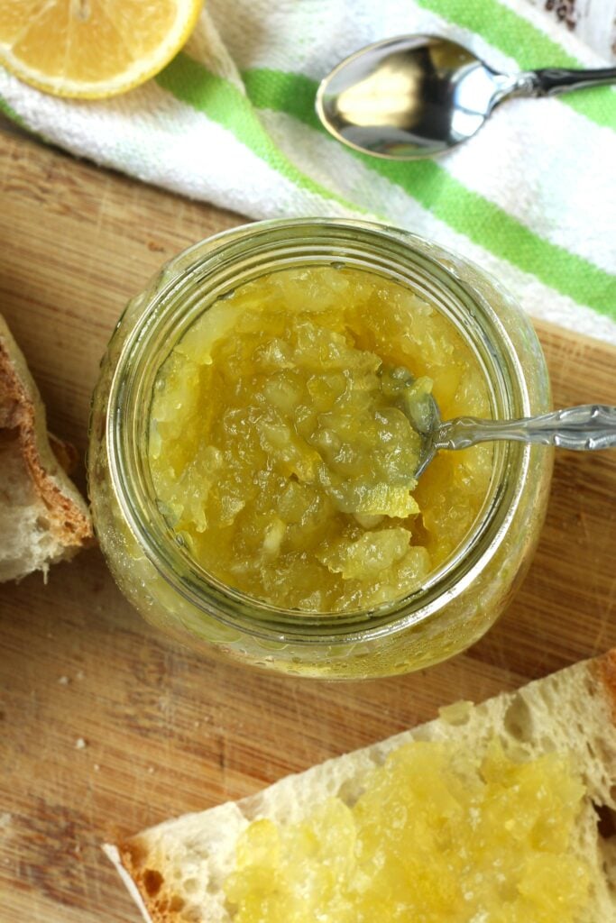 Overhead view of zuccata jam in jar with spoon in it.