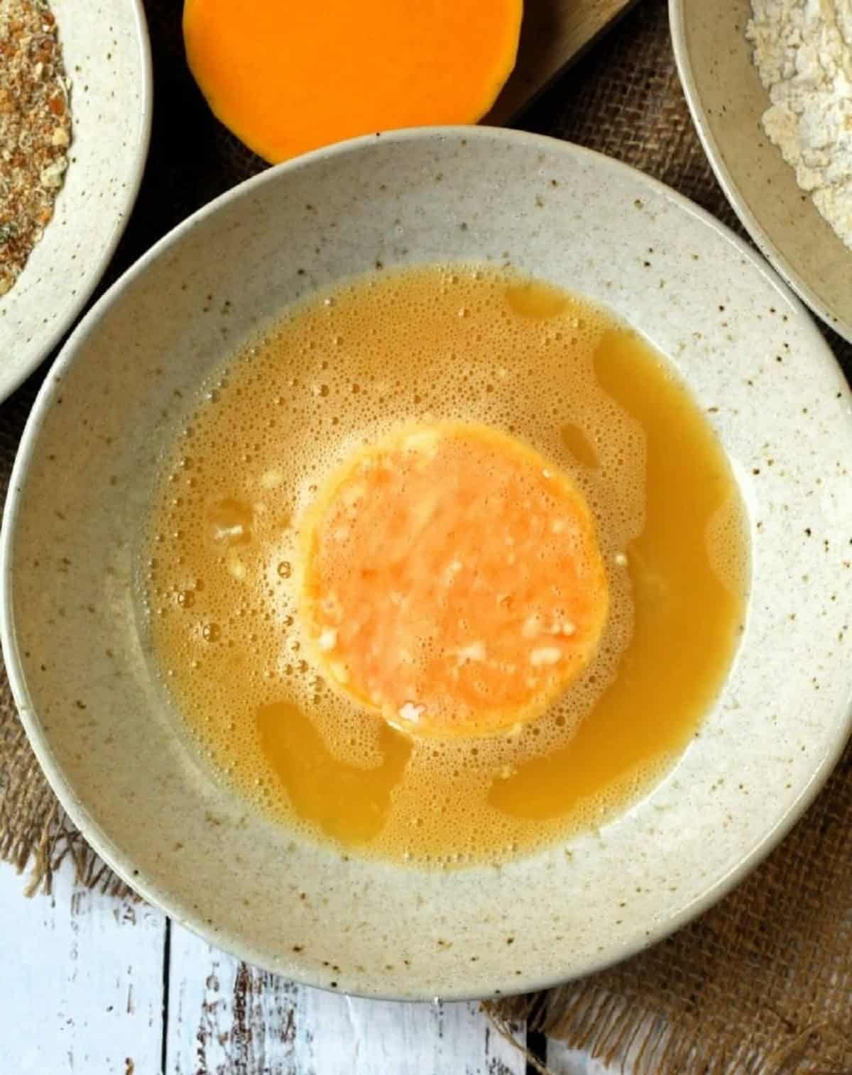 Dredged butternut suqash cutlet in egg wash.